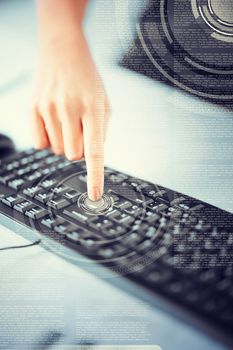 business, education and technology concept - woman hand pressing on enter button on keyboard