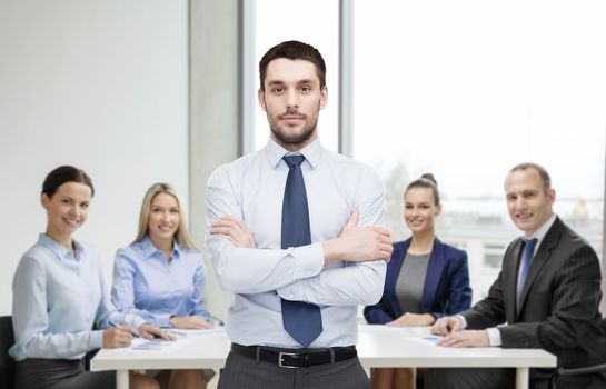 business and office concept - handsome businessman with crossed arms