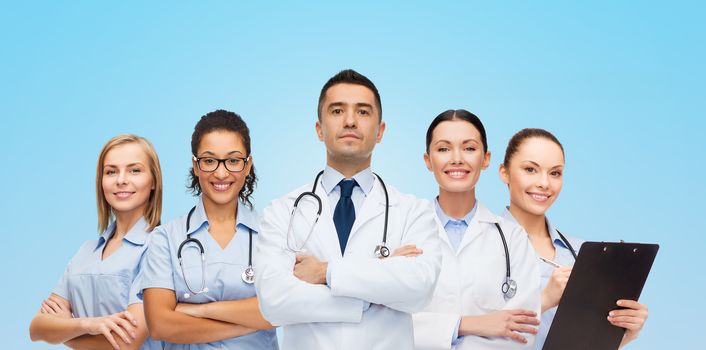 healthcare, profession, people and medicine concept - group of medics with stethoscopes over blue background
