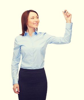 office, business and new technology concept - smiling businesswoman writing something in the air with marker