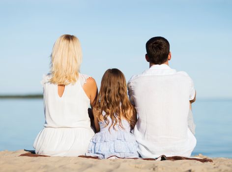 summer holidays, celebration, children and people concept - happy family at the seaside