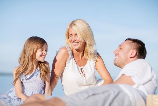 summer holidays, children and people concept - happy family having a picnic