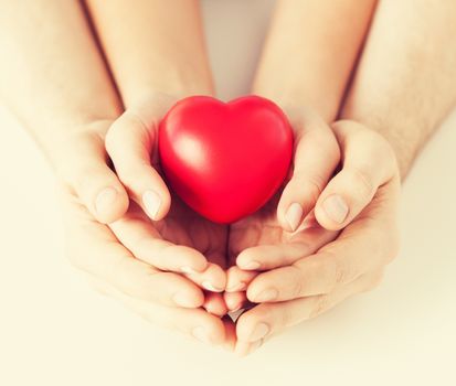 close up of woman and man hands with heart