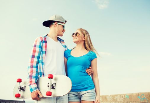 holidays, vacation, love and friendship concept - smiling couple having fun outdoors