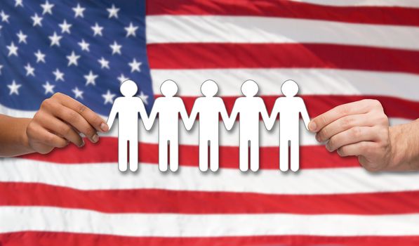 community, unity, international, social equality and teamwork concept - close up of multiracial couple hands holding paper chain people over american flag background