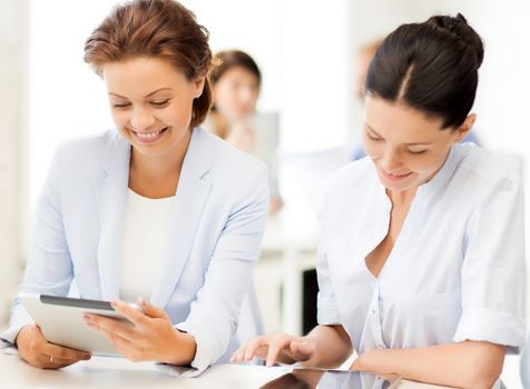 smiling business team working with tablet pc in office