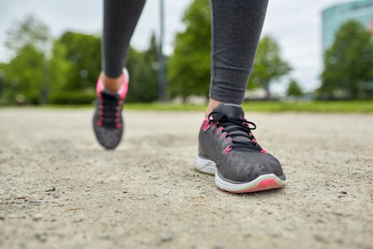fitness, sport, training, people and lifestyle concept - close up of woman feet running on track from back