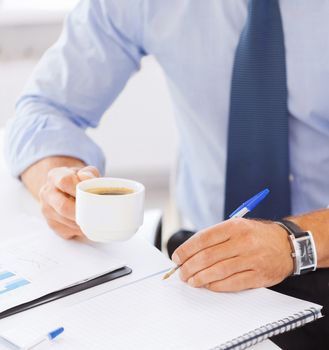 business and education concept - businessman drinking black coffee in office