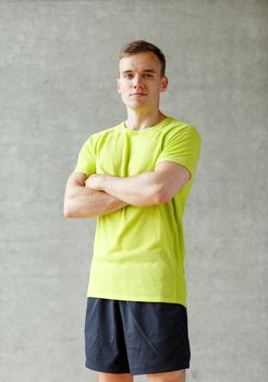 sport, fitness, lifestyle and people concept - smiling man in gym