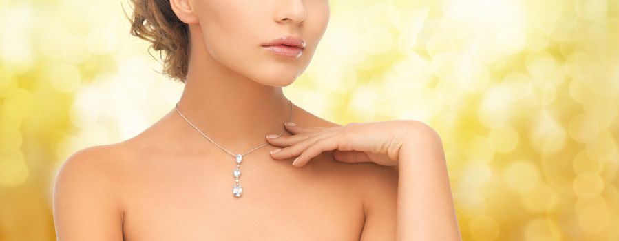 wedding, bridal, jewelry and luxury concept - beautiful woman wearing shiny diamond necklace