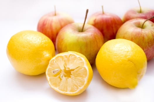 Fruits conceptual image. Apples and lemons on isolated background.