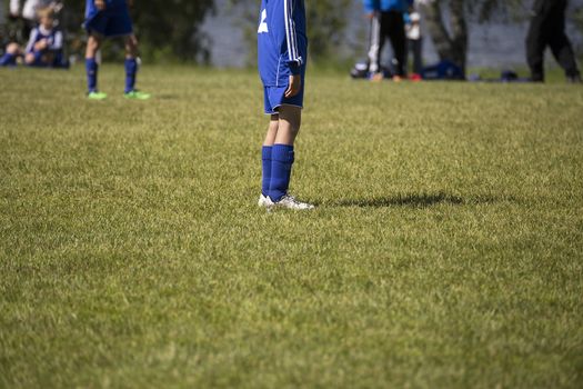 A soccer player in the middle of the field wating