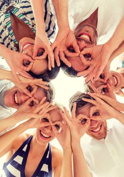 friendship, happiness and people concept - smiling friends in circle