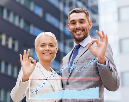 business, partnership, gesture success and people concept - smiling businessman and businesswoman making ok gesture over office building background