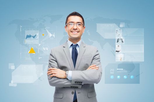 business, people, development and technology concept - happy smiling businessman in suit working with virtual screens over blue background