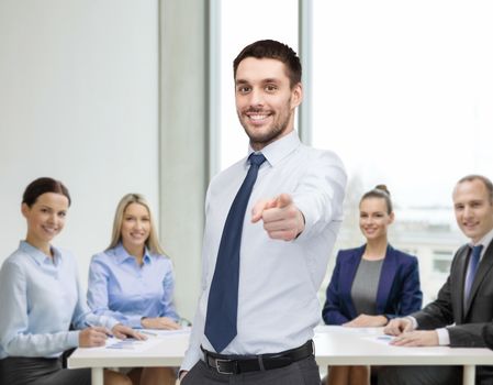 business, gesture and office concept - handsome businessman pointing finger at you