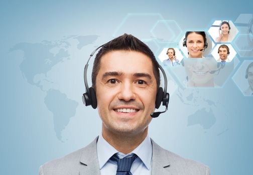 business, people, technology and communication concept - smiling businessman in headset over virtual contacts icons projection and blue background