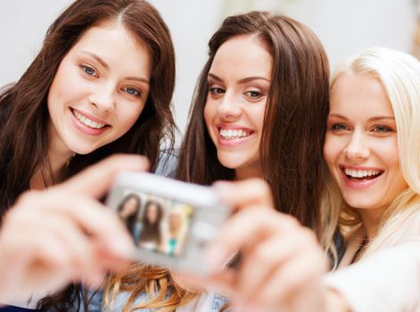 holidays and tourism concept - beautiful girls taking selfie in the city