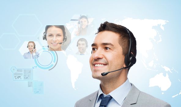 business, people, technology and communication concept - smiling businessman in headset over virtual contacts icons projection and blue background