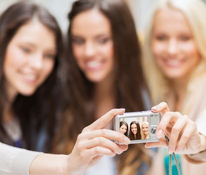 holidays and tourism concept - beautiful girls taking selfie in the city