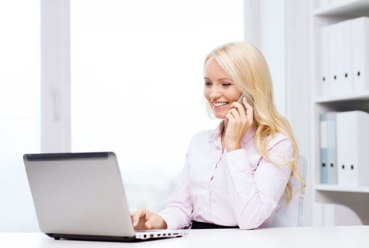 education, business, communication and technology concept - smiling businesswoman or student with laptop computer calling on smartphone in office