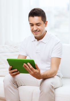 technology, people and lifestyle, distance learning concept - happy man working with tablet pc computer at home