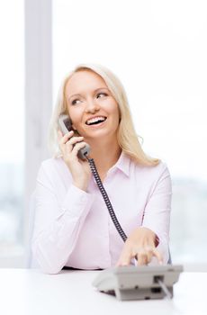 education, business, communication and technology concept - smiling businesswoman calling on phone in office