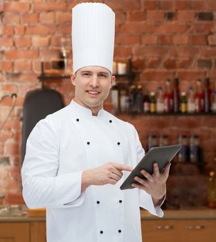 cooking, profession and people concept - happy male chef cook holding tablet pc computer over kitchen background