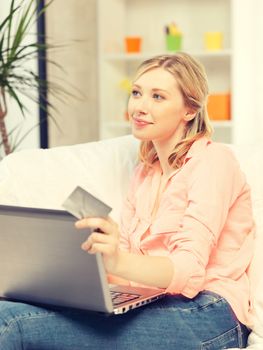 picture of happy woman with laptop computer and credit card..