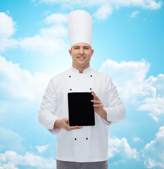 cooking, profession and people concept - happy male chef cook showing tablet pc computer black blank screen over blue sky with clouds background