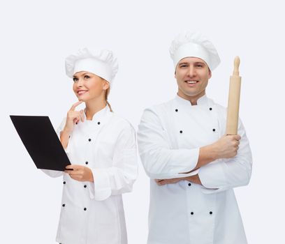 cooking, profession and people concept - happy male chef cook holding rolling pin