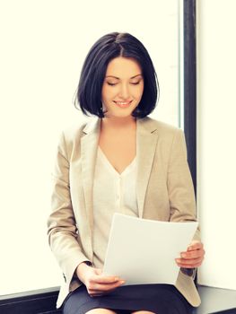 indoor picture of happy woman with documents