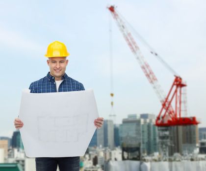 repair, construction, building, people and maintenance concept - smiling male builder or manual worker in helmet with blueprint over city construction site background
