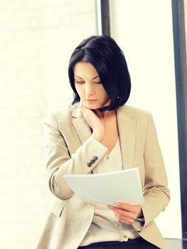 indoor picture of calm woman with documents