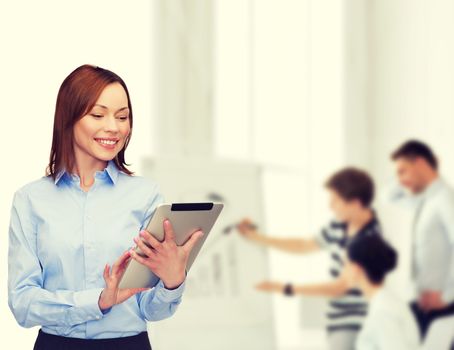 business, internet and technology concept - smiling woman looking at tablet pc computer at office