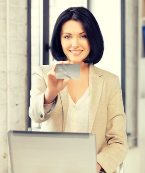 picture of happy woman with laptop computer and credit card.