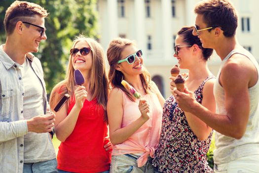 friendship, leisure, sweets, summer and people concept - group of smiling friends with ice cream outdoors