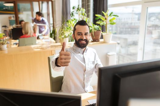 business, startup, gesture and people concept - happy businessman or creative male office worker with computer showing thumbs up