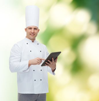cooking, profession and people concept - happy male chef cook holding tablet pc computer over green background