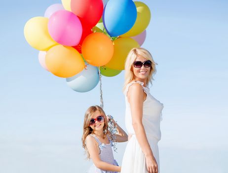 summer holidays, celebration, family, children and people concept - mother and child with colorful balloons