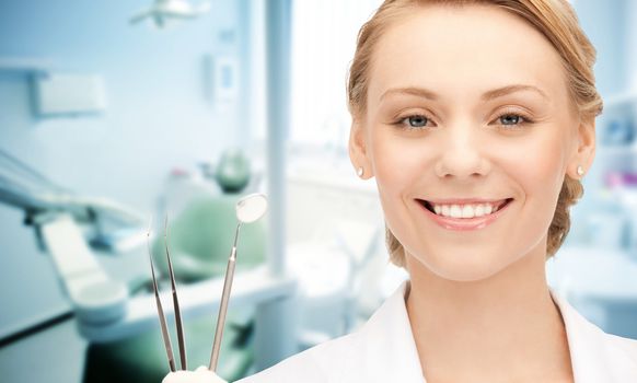 people, medicine, stomatology and healthcare concept - happy young female dentist with tools over medical office background