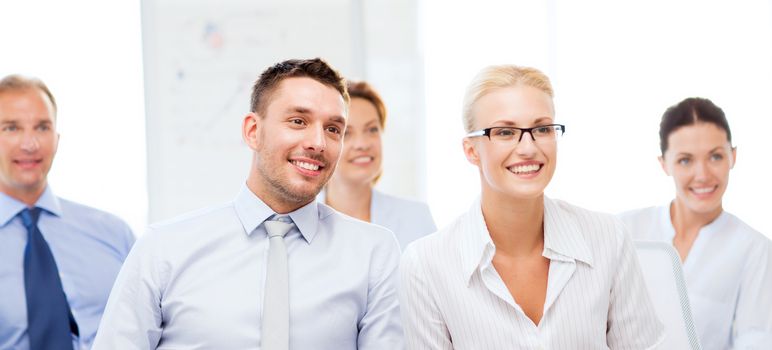 picture of smiling businessmen and businesswomen on conference