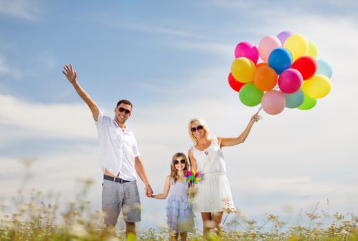 summer holidays, celebration, children and people concept - family with colorful balloons