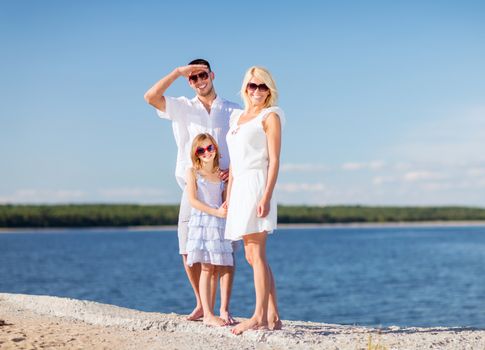 summer holidays, children and people concept - happy family with blue sky