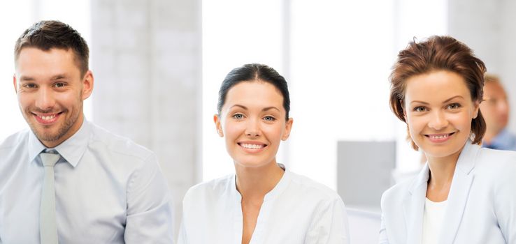 smiling business team discussing something in office