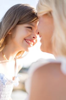 summer holidays, family, children and people concept - happy mother and child girl outdoors