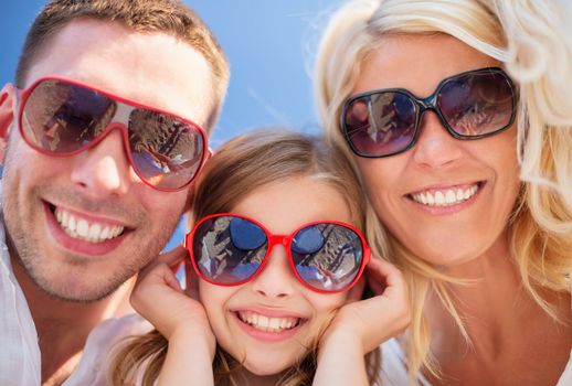 summer holidays, children and people concept - happy family with blue sky