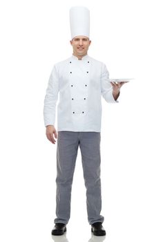 cooking, profession, advertisement and people concept - happy male chef cook showing something on empty plate