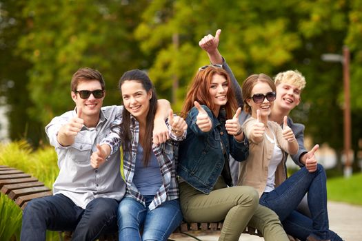 summer holidays, education, campus and teenage concept - group of students or teenagers showing thumbs up