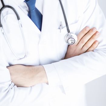 close up of doctor with stethoscope in white uniform